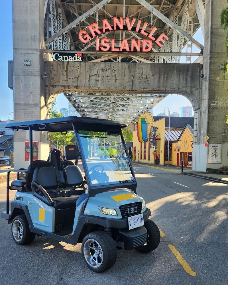 A HeyYa cart beneath the Granville Island entrance sign in Vancouver